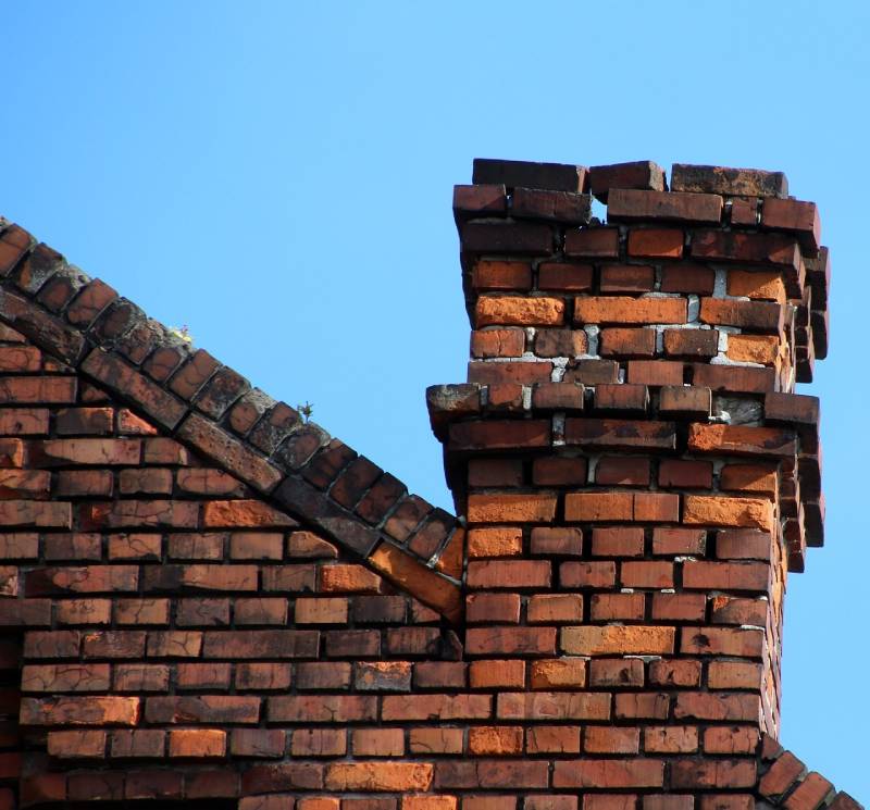 Signs Your Hometown Home Needs a Chimney Inspection Damaged chimney on an Hometown home showing cracks and missing mortar